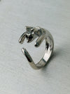 Adorable silver-tone cat hug adjustable ring wrapping around finger, displayed on a white background.