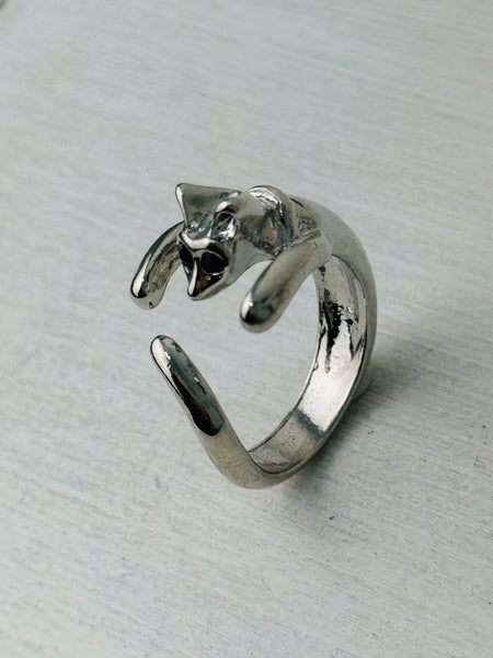 Adorable silver-tone cat hug adjustable ring wrapping around finger, displayed on a white background.