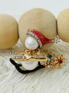 close-up of christmas snowman pearl sleigh brooch