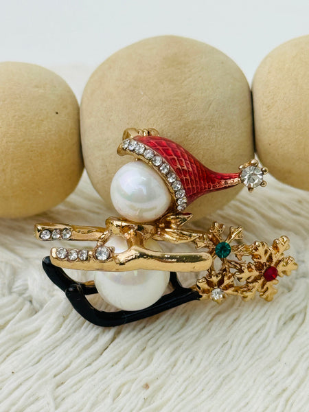 close-up of christmas snowman pearl sleigh brooch