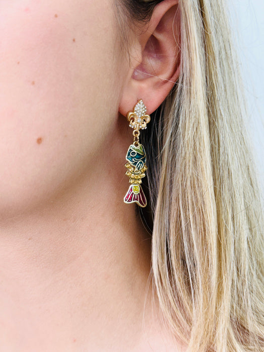 Close-up of a person wearing a colorful earring with a detailed design.