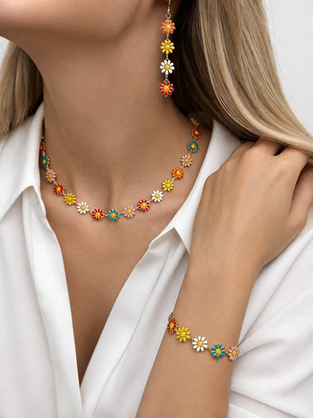 Colorful floral necklace and earrings on a model wearing a white shirt.