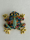 close-up of multicoloured crystal frog brooch 