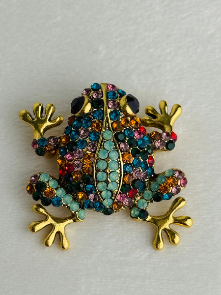 close-up of multicoloured crystal frog brooch 