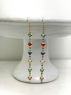 Multicolored heart-shaped bead earrings on a white pedestal