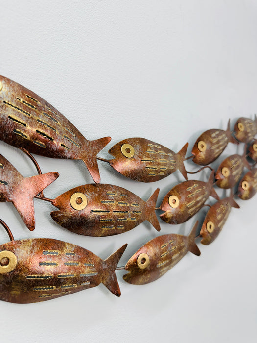 Close-up of mottled copper metal fish showing gold detailing and textured finish