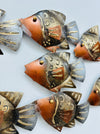 Close-up of copper mottled metal fish showing engraved detailing and gold accents