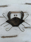 Back of green metal crab wall art showing hanging eyelet and metal structure