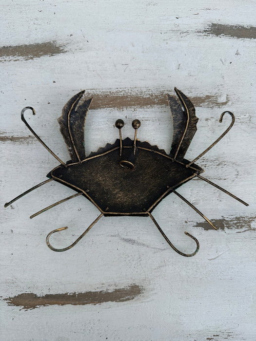 Back of green metal crab wall art showing hanging eyelet and metal structure