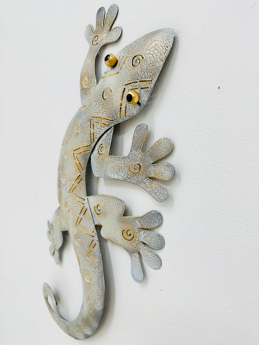 Angled view of white and gold metal gecko showing hand-painted crackle details