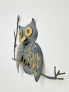 Side view of crackle-effect metal owl wall art showing hand-painted details.