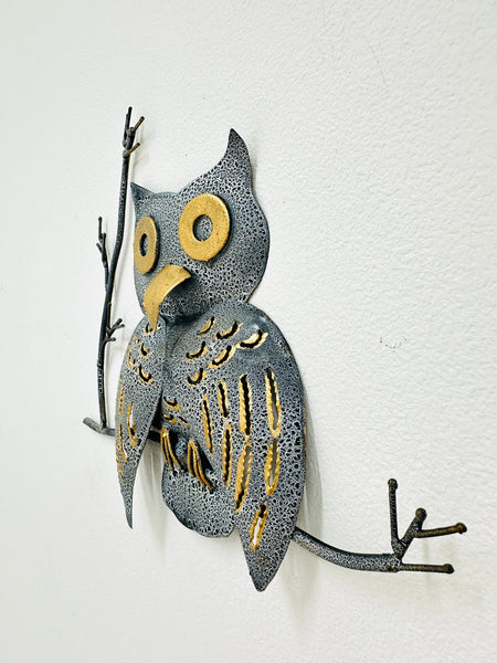 Side view of crackle-effect metal owl wall art showing hand-painted details.