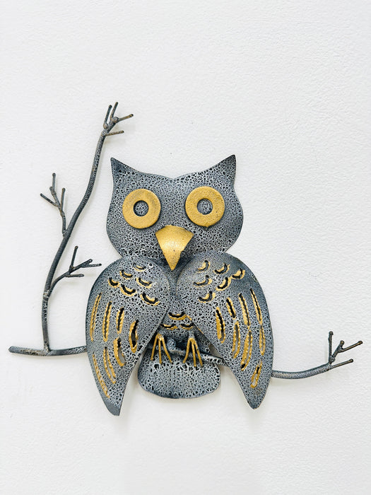 Handmade crackle-effect owl wall art in grey and gold, mounted on a branch against a light background.
