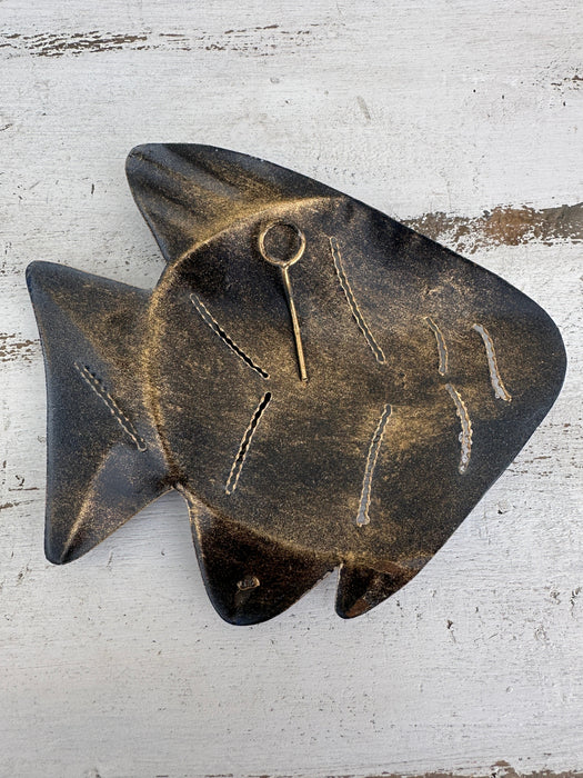 Back of turquoise metal fish wall art showing hanging point
