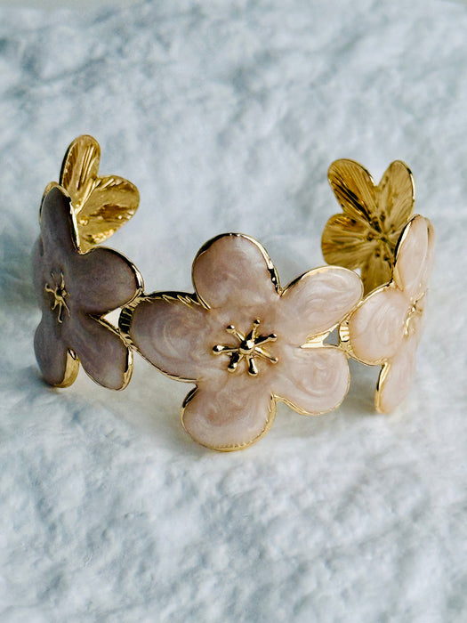 Floral bracelet with gold accents on a textured surface