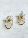 Floral earrings with gold centers on a light background