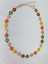 Colorful flower-shaped necklace on a light gray background