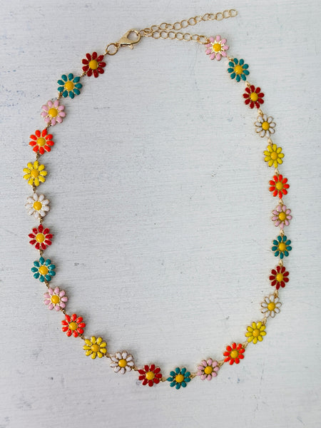 Colorful flower-shaped necklace on a light gray background