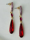 Elegant 7 cm long drop earrings with amethyst-purple, ruby-red and deep-red  crystals in gold-tone finish.