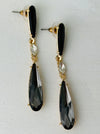 Elegant 7 cm long drop earrings with black stones, clear crystal and smoky teardrop in gold-tone finish.