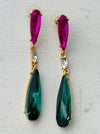 Elegant 7 cm long drop earrings with purple, clear crystal and emerald green teardrop in gold-tone finish, displayed on a white background.
