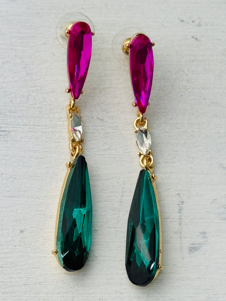 Elegant 7 cm long drop earrings with purple, clear crystal and emerald green teardrop in gold-tone finish, displayed on a white background.