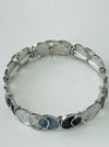 Silver-plated bracelet with circular design on a white background