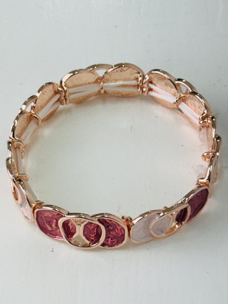 Elastic Aurea bracelet with rose-gold enamel circular design in gold-tone finish.