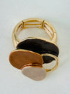 Gold-tone elastic ring with three layered enamel discs in bronze.