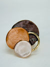 Gold-tone elastic ring with three layered enamel discs in bronze.
