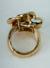 Back view of adjustable enamel ring with elastic band in gold tone.