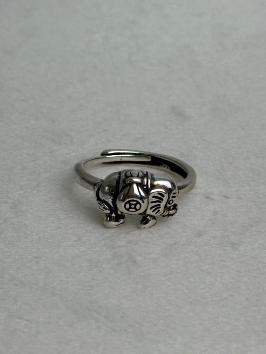 Silver ring with a detailed design on a light gray background