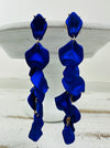 12 cm long statement drop earrings with cascading matte royal blue acrylic petals and gold-tone metal accents.