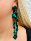 12 cm long statement drop earrings with cascading matte dark green acrylic petals and gold-tone metal accents, displayed on a model.