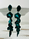 12 cm long statement drop earrings with cascading matte dark green acrylic petals and gold-tone metal accents.