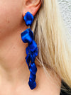 12 cm long statement drop earrings with cascading matte royal blue acrylic petals and gold-tone metal accents, displayed on a model.