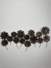 Back view of the metal daisy wall sculpture showing hanging structure
