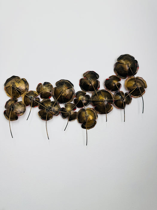 Back view of red poppy wall sculpture showing metal frame and mounting points