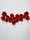 Hand-painted red metal poppy wall sculpture with layered flowers on a white background