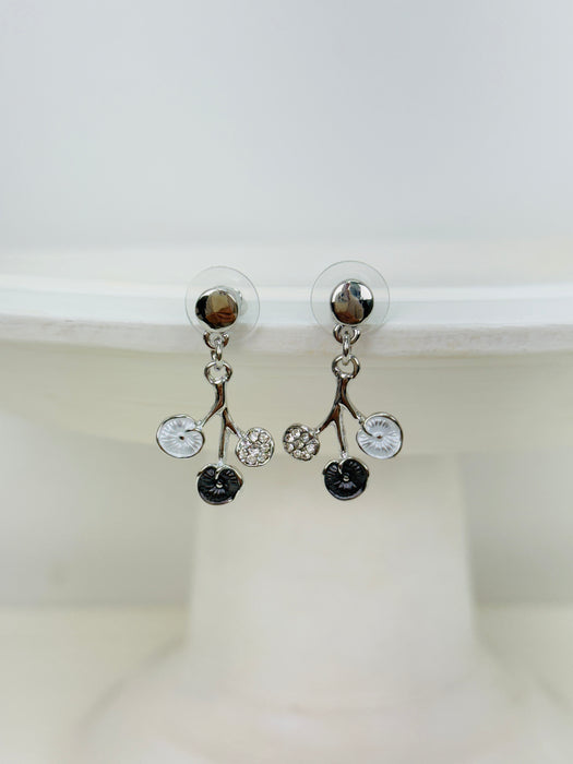 White and grey floral enamel drop earrings with crystal effect glass stones on a silver-tone branch design, dispayed on a white background.