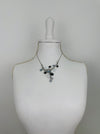 White and dark grey floral enamel necklace with crystal effect glass stones an a silver-tone chain, displayed on a mannequin.