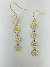 A sweet floral dangle earrings, displayed on a table.