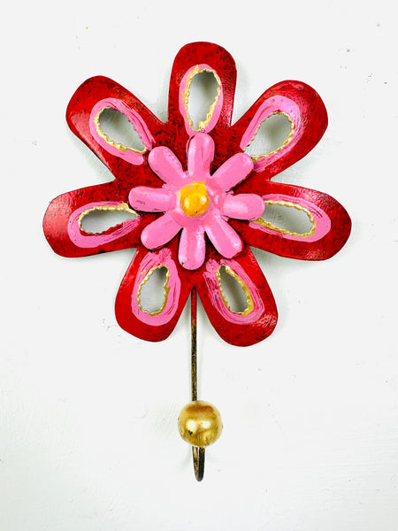 Handmade red and pink flower-shaped metal wall hook with gold detailing.