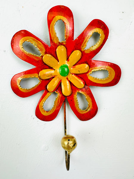 Handmade yellow and orange flower-shaped metal wall hook with gold detailing.