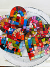 Group of Fragaria heart-shaped mosaic coasters with colourful hand-painted glass pieces on MDF bases, photographed from above on a light textured surface.