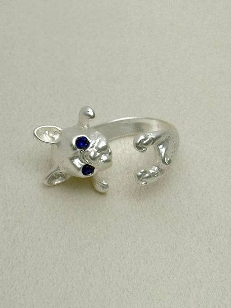 silver tone French bulldog puppy open ring with blue eyes on a white background