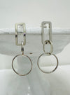 front view of geometric silver drop earrings with rectangular and circular linked shapes