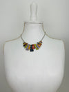 Multicoloured rectangular-shaped enamel statement necklace on a mannequin bust.