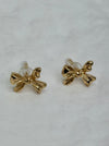 close-up of small gold bow earrings