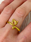 Gold cat-shaped ring on a model